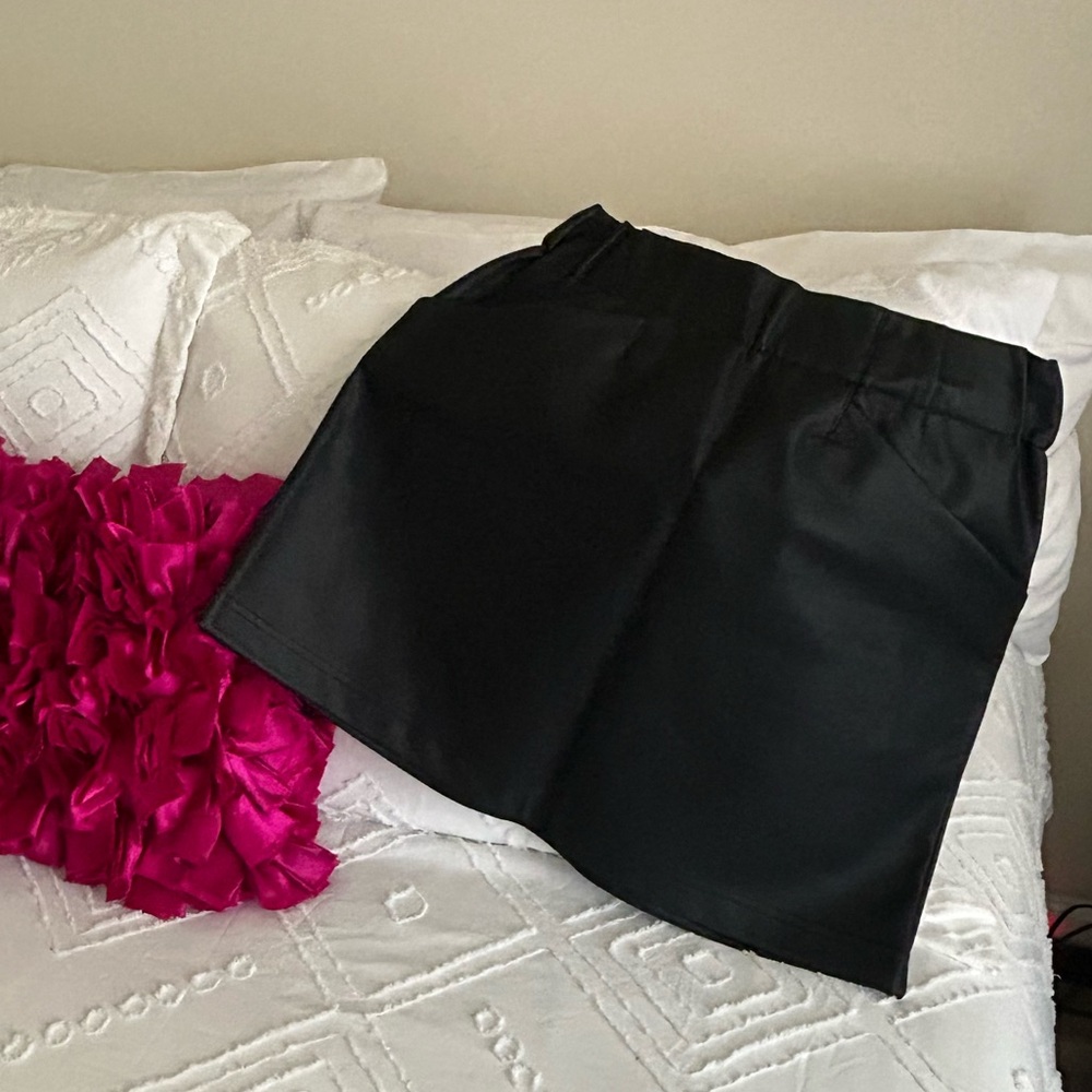 Black faux leather skirt with pockets.